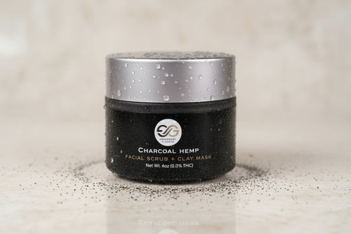 Black jar with silver lid on a gray background